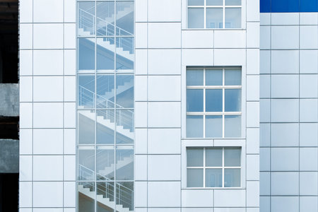 The exterior of a contemporary building showcases a sleek design with a visible internal glass...
