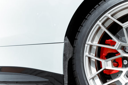 Detailed view of a performance vehicle's wheel assembly, showcasing the intricate design of the...