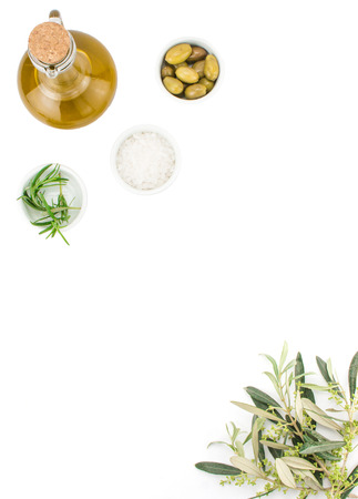 Glass bottle of premium virgin olive oil, sea salt, rosemary and some olives with olive branch isolated on a white background. Top viewの写真素材