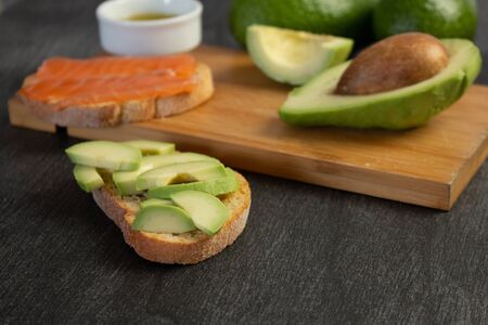 Salmon on bread slices gourmet appetizer with avocado. Fresh salmon   and avocado sandwich. Healthy...