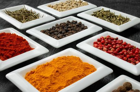 Colorful spices in white bowls Seasonings for cooking. Natural Herbs & Spices.