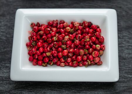 Red pepper or Pink pepper. Colorful spices in white bowls Seasonings for cooking. Natural Herbs &...