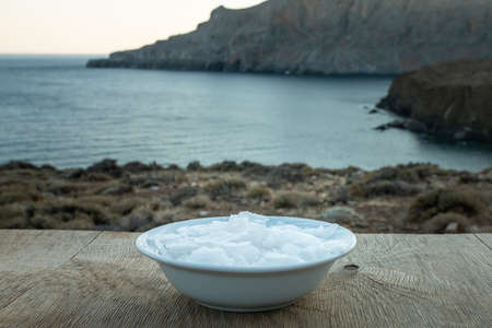 Flower of Greek sea salt crystals, south Crete. Natural traditional Fleur de sel from Crete. Sea salt flakes on wooden bakcground.の写真素材