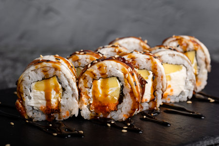 Set of fresh tasty philadelphia sushi rolls with soy on a dark background.の写真素材