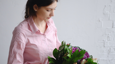 Florist girl check bouquet of different flowersの写真素材