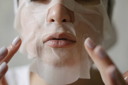 Cleansing and moisturizing female skin with a facial mask. Natural cosmetics with bio componentsの写真素材