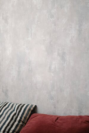 Two beautiful pillows against a grey wall. Stylish modern interior, concept of cosiness and comfort.の写真素材
