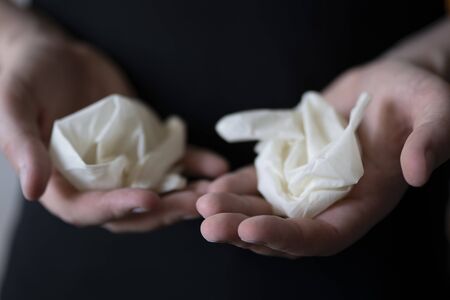Used medical gloves in mens hands. Protection from coronavirus during a pandemic. Professional...