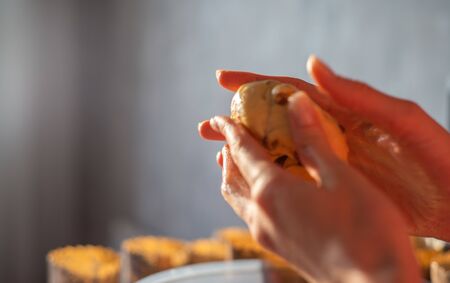 Rolling out the dough ball close-up in the womens hands. Cooking baking in a bakery