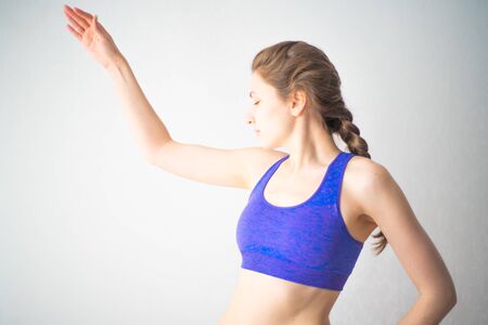 Engage in sports online at home isolation. Stretching exercises, training of muscles of the back on a white backgroundの写真素材