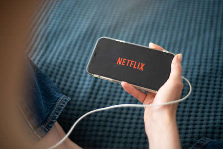 Netflix logo on Apple iPhone. Streaming video on a mobile device.のeditorial素材
