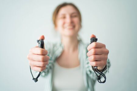 Joystick in womens hands. Game controllers for virtual reality. Happy woman shows off gamepads and...
