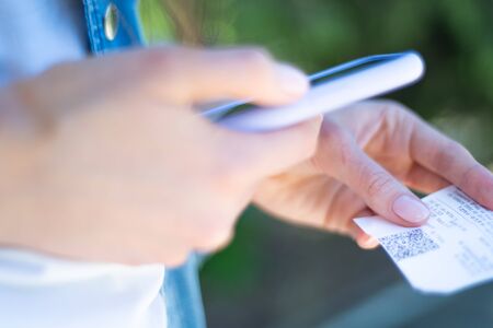 Qr Scan. Person scans qr code on a check from a smartphone, close-up. Financial accounting using a mobile appの写真素材