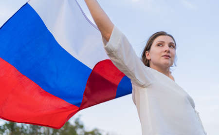 The symbol of Russia - flag in the hands of a woman. Independence and patriotismの写真素材