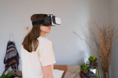 A person from the back in a VR headset. Internet-connected technology for ecommerce