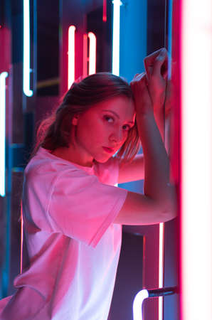 Vertical shot - portrait in the neo. Model in a nightclubの写真素材