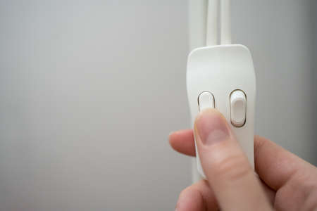 Turn off the lights. White switch close-upの写真素材