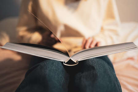 Open book. The person reads literature. close-up. Student in the library, education