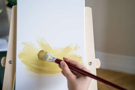 The artist paints a picture with a brush, a close-up. Abstract drawingの写真素材