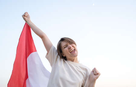 Portrait of an emotional woman with the flag of France. Football fanの写真素材