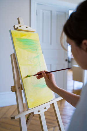 A young artist paints in oil. Painter entrepreneurの写真素材
