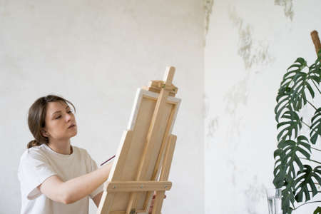 Creation of a work of art. A concentrated artist in the process. Student at drawing lesson