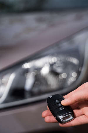 Person opens the car with the keys. Remote access to automobile. Keys for transport signaling....