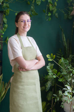 Female florist in an apron. Young businesswomen. Kind of employment. Shopkeeperの写真素材
