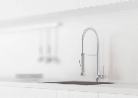Fragment of a kitchen with wooden white facades, with granite countertops and an apron. Kitchen...