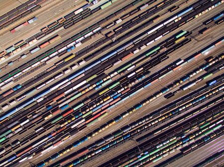 Aerial view of cargo trains. Railway wagons with goods on railroad.