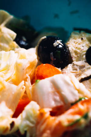 plate of fresh salad  with dark olives and tomatoes.の写真素材