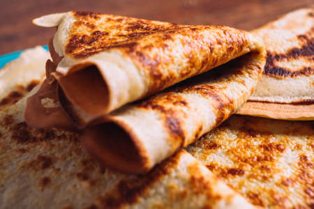 lot of pancakes on a blue  plate on a blurred background