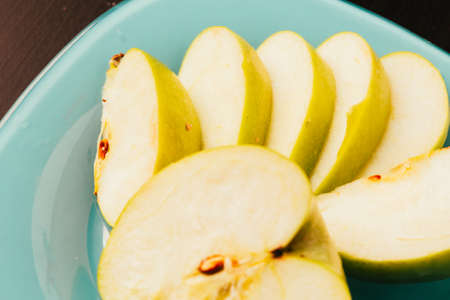 Fresh pieces of chopped apple close-up on plate
