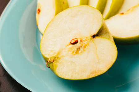 Fresh pieces of chopped apple close-up on plateの写真素材