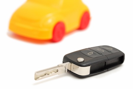 Auto remote control key and car isolated on white backgroundの写真素材