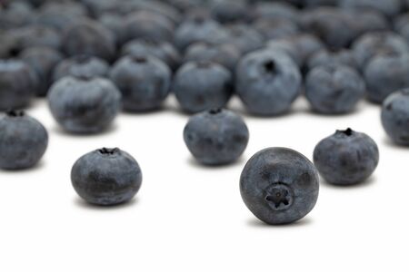 Scattered ripe blueberry isolated on white backgroundの写真素材