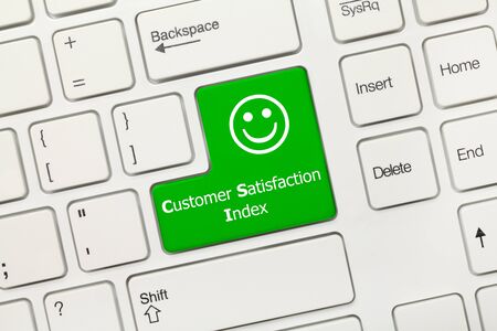 Close-up view on white conceptual keyboard - Customer Satisfaction Index (green key)の写真素材