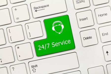Close-up view on white conceptual keyboard - 24/7 Service (green key with operator symbol)の写真素材