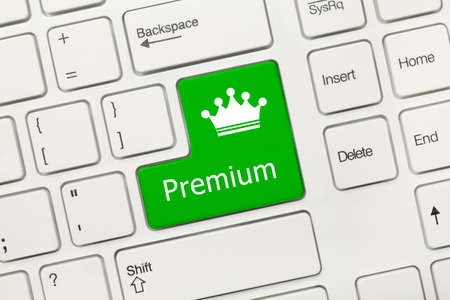 Close-up view on white conceptual keyboard - Premium (green key)の写真素材