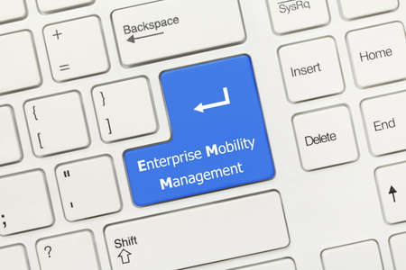 Close-up view on white conceptual keyboard - Enterprise Mobility Management (blue key)の写真素材