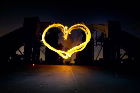fair show in the form of a heart on a bridge at night under the starsの写真素材