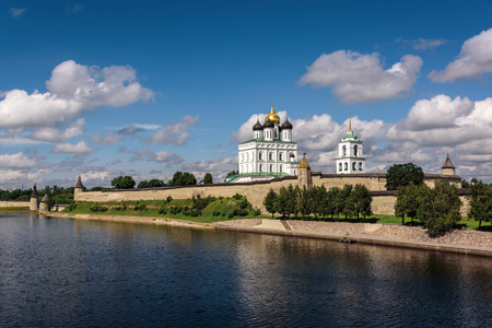 View of the Pskov Kremlin from the bridge through the river in the summer afternoonの写真素材