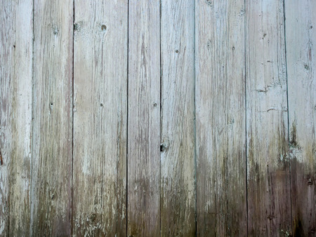 The old plastered background on a building wall with cracks and chipsの写真素材