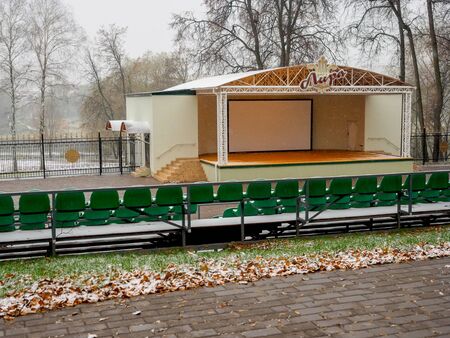 Outdoor theater in the park in the fall after the first snowfall. An amphitheater and places for the audience.の写真素材