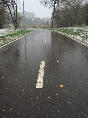 Sign on a wet bicycle path after the thawed snow in the fallの写真素材