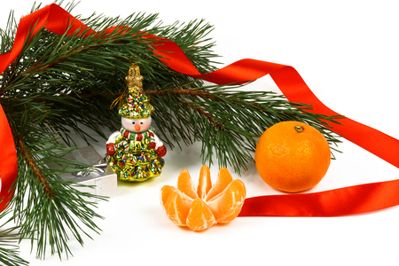 Tangerine, snowman and green pine branches on a white background.の写真素材