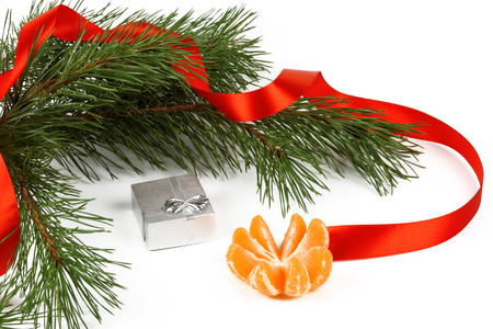 Tangerine, silver box and green pine branches on a white background.の写真素材