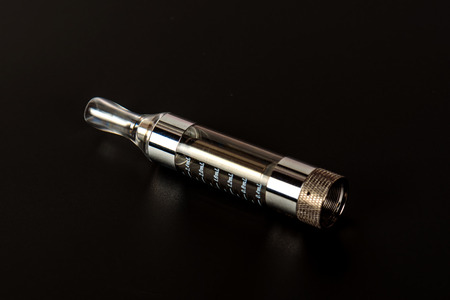 Electronic cigarette (vape) in the sorted look against a dark background.の写真素材