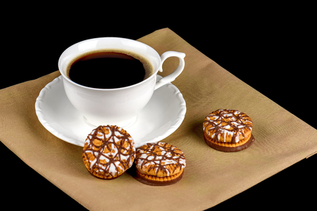 Chocolate cookies and a cup of coffee on a black backgroundの写真素材