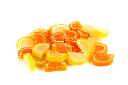 Marmalade in the form of lemon and orange slices on a white backgroundの写真素材